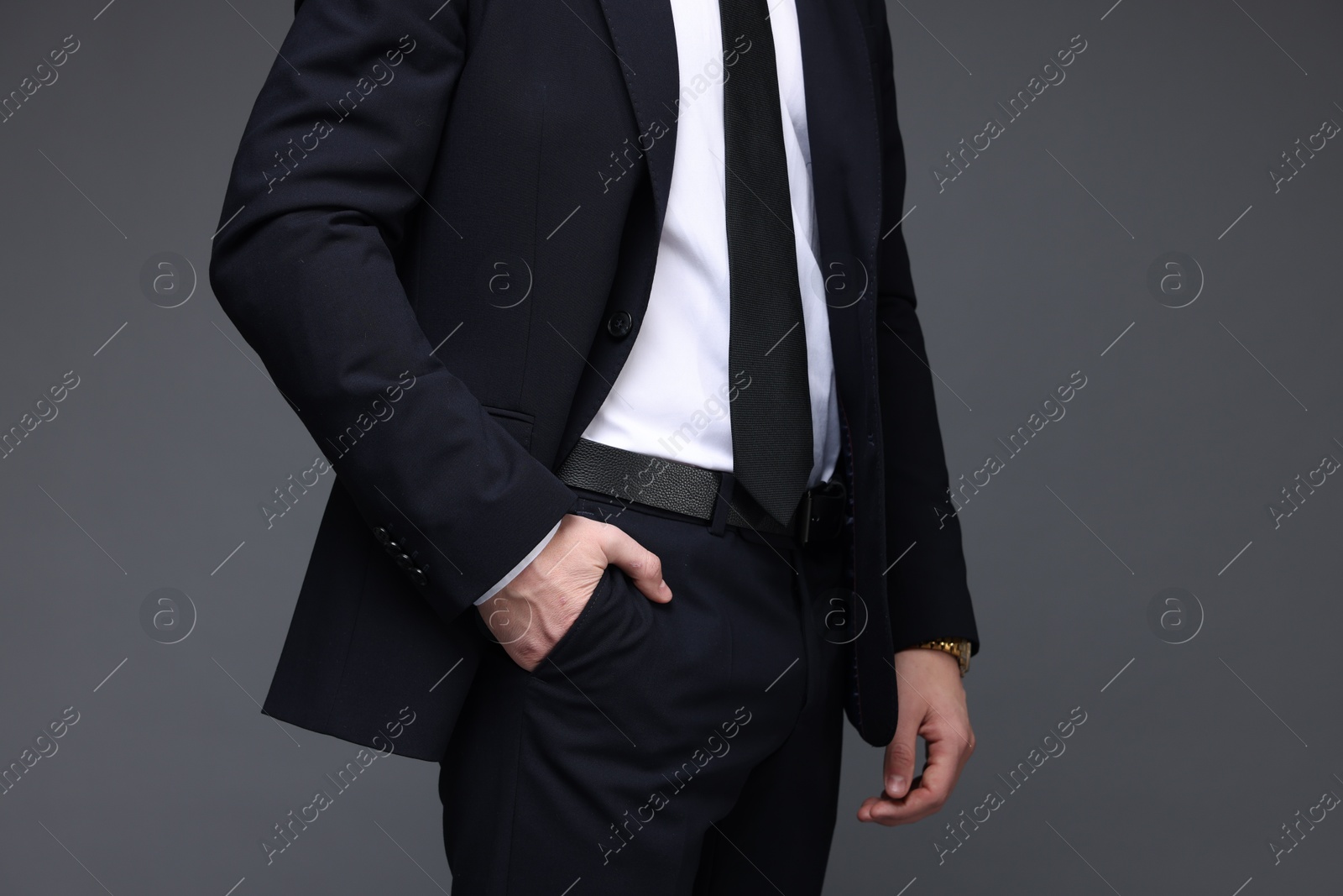 Photo of Man in classic suit on grey background, closeup