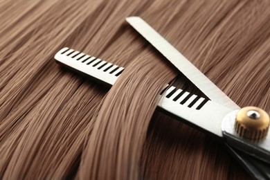 Image of Beautiful hair in mocha mousse shade and hairdresser's scissors, closeup. Trendy color of 2025 year