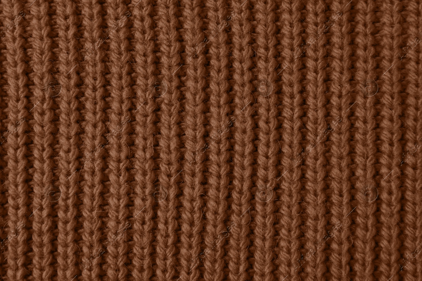 Image of Knitted fabric in mocha mousse shade, closeup. Trendy color of 2025 year