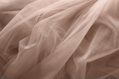 Image of Tulle fabric in mocha mousse shade, closeup. Trendy color of 2025 year