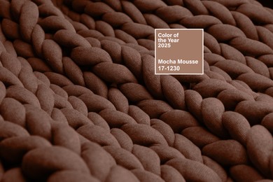 Image of Mocha mousse - color of 2025 year. Knitted fabric in brown shade, closeup