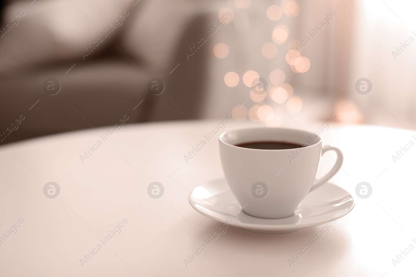 Image of Coffee on table indoors, toned in mocha mousse shade. Trendy color of 2025 year