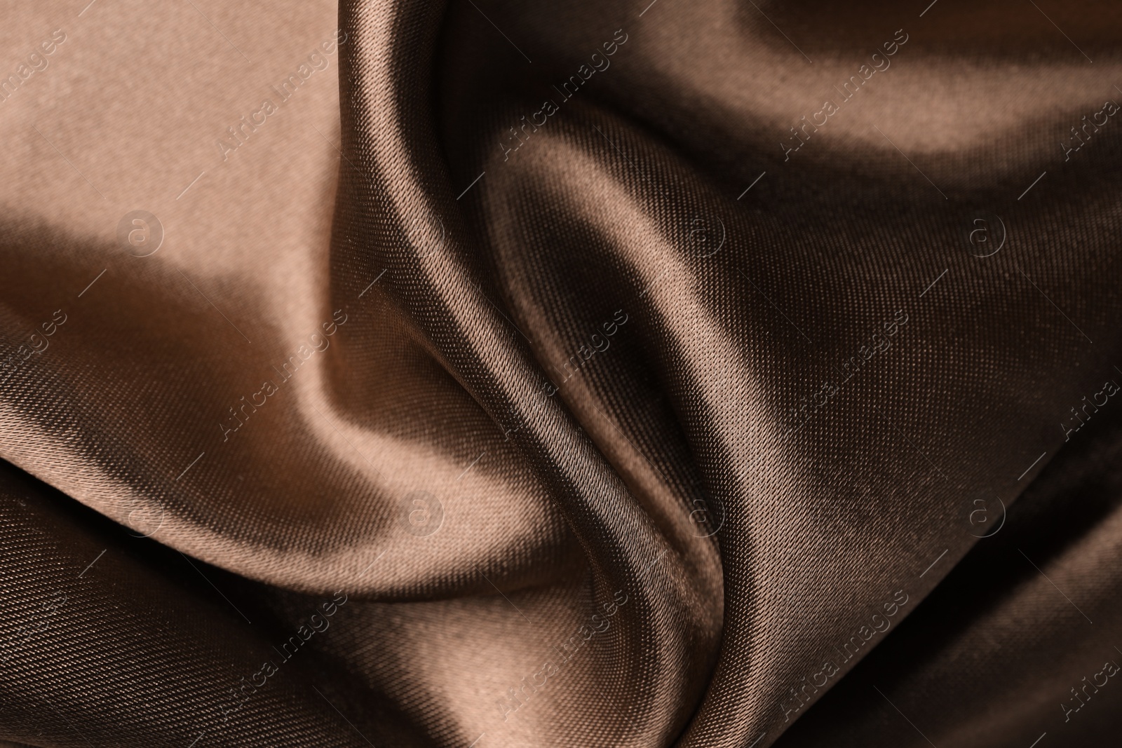 Image of Silk fabric in mocha mousse shade, closeup. Trendy color of 2025 year