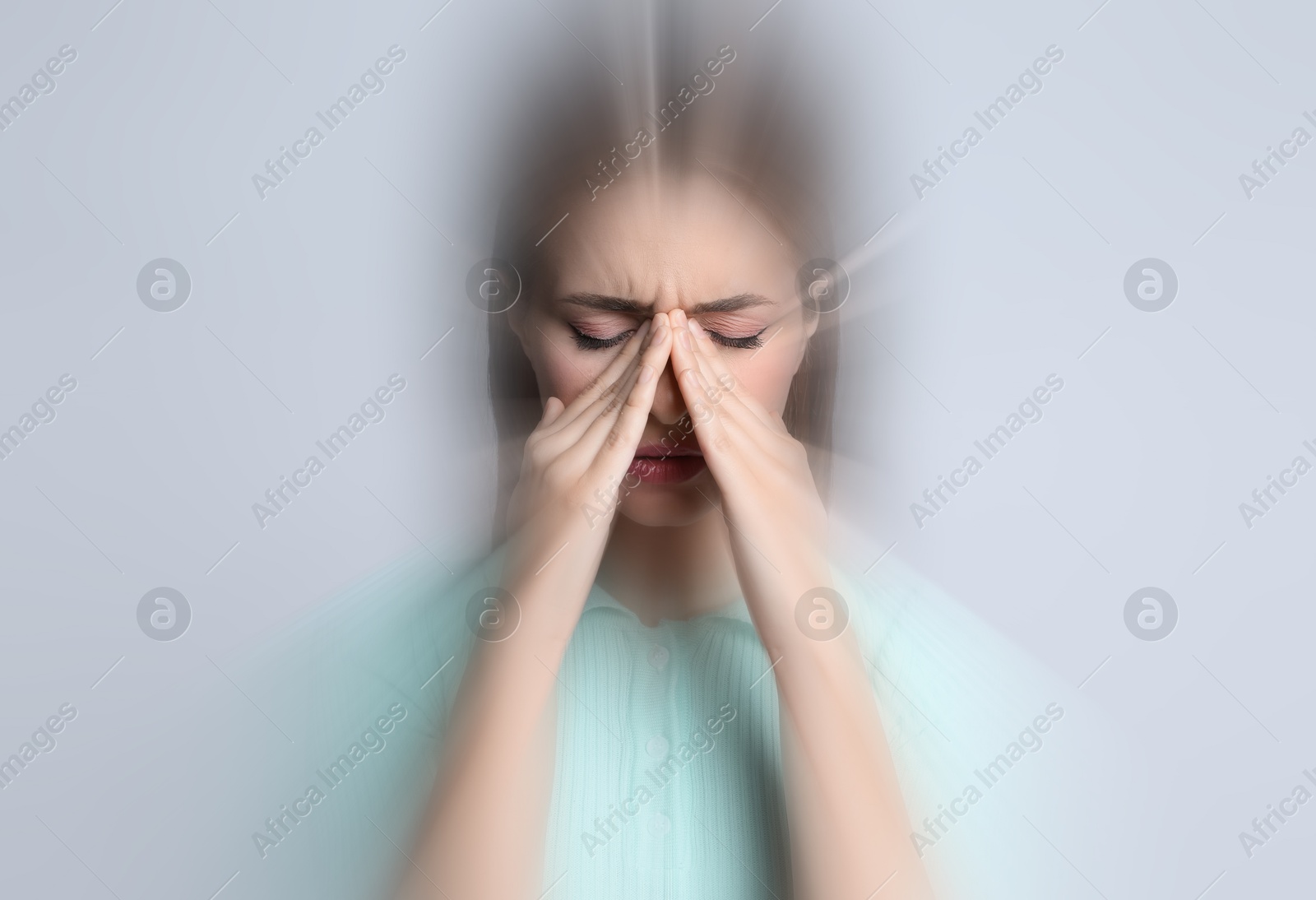 Image of Woman suffering from headache and dizziness on grey background