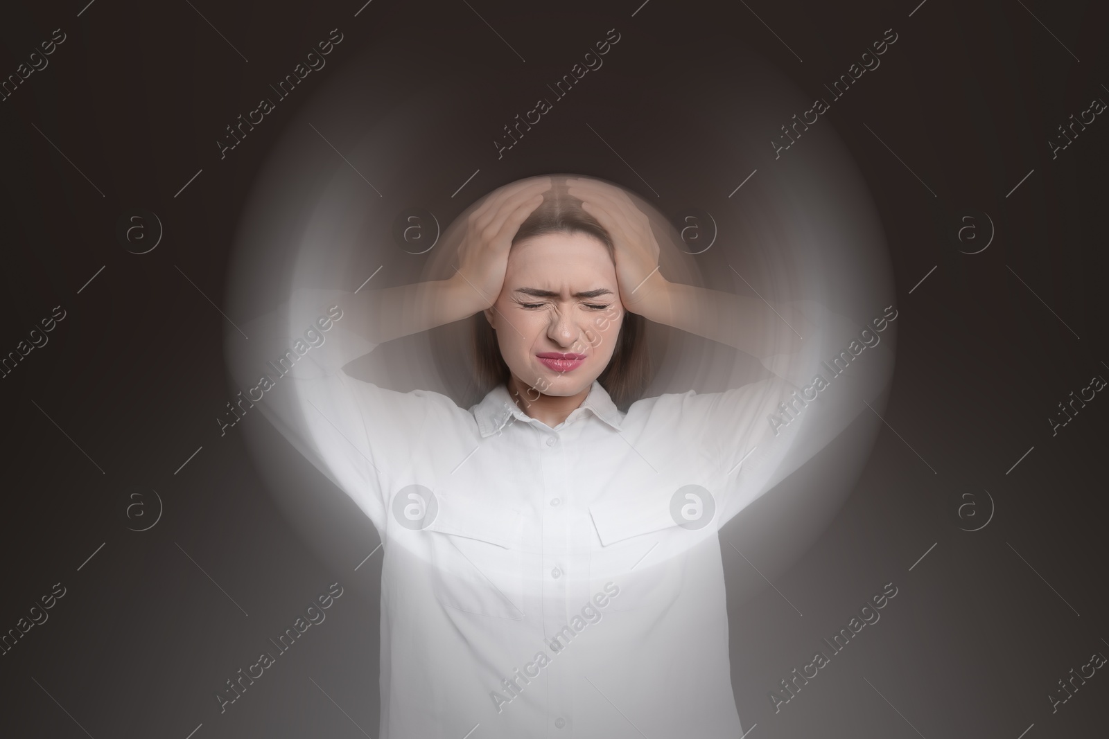 Image of Woman suffering from headache and dizziness on dark brown background