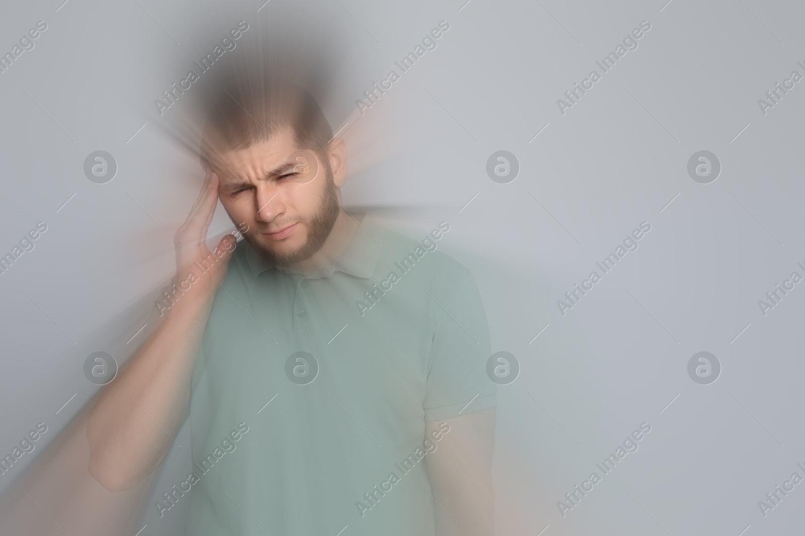 Image of Man suffering from headache and dizziness on grey background