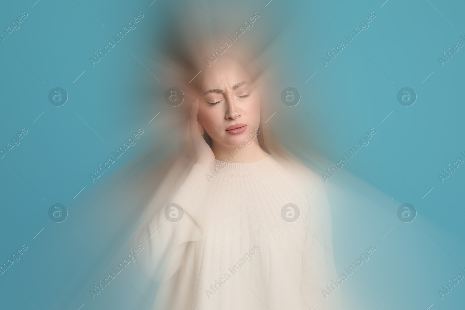 Image of Woman suffering from headache and dizziness on light blue background