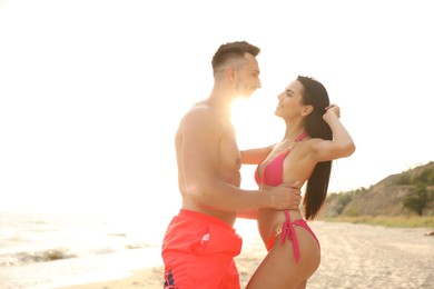 Photo of Happy young couple on beach on sunny day