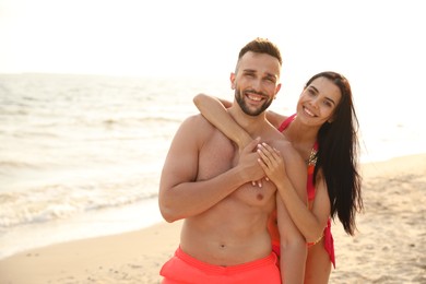 Photo of Happy young couple on beach on sunny day