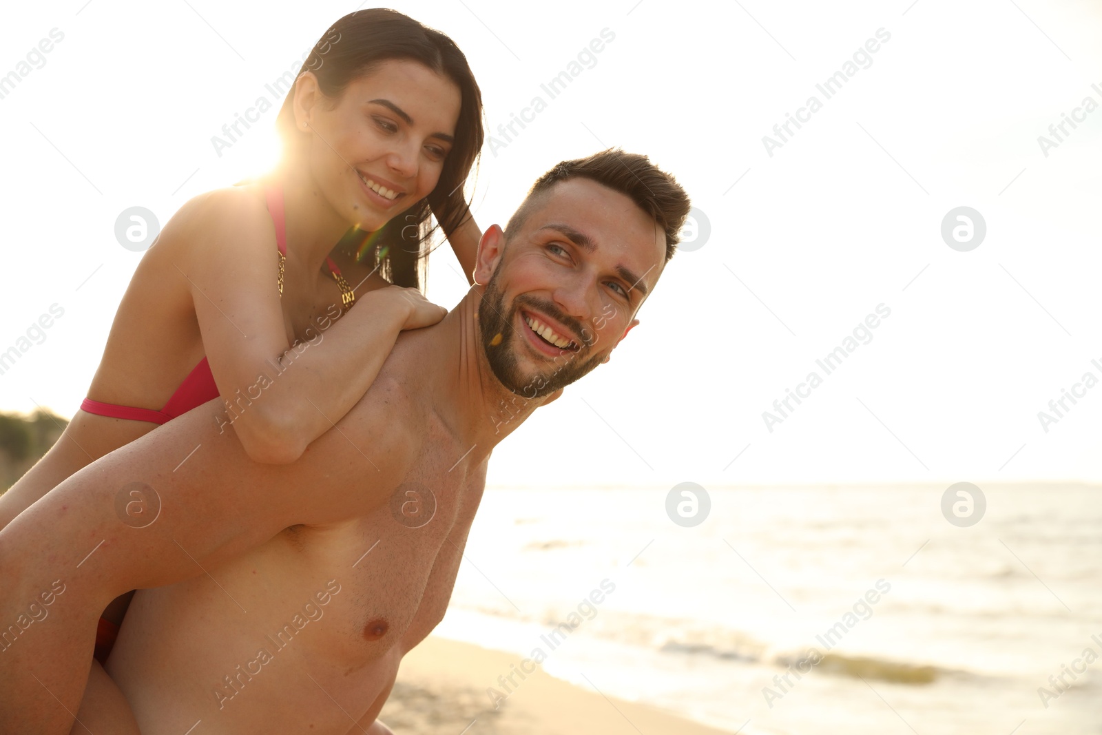 Photo of Happy young couple having fun on beach on sunny day