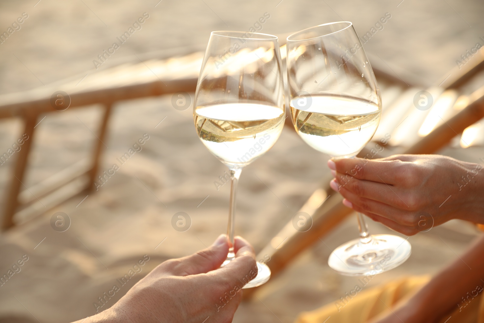 Photo of Romantic couple drinking wine together on beach, closeup