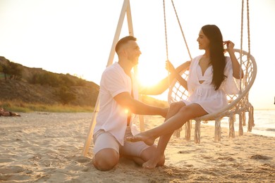 Photo of Happy young couple on beach at sunset