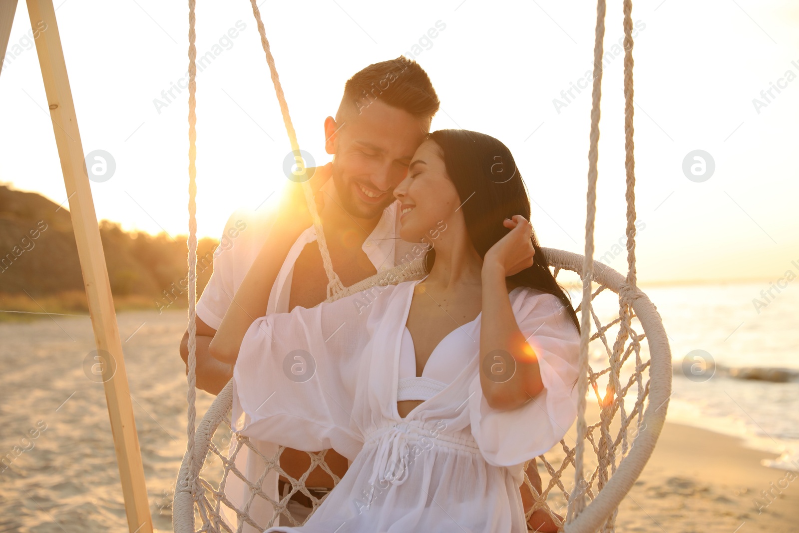 Photo of Happy young couple on beach at sunset