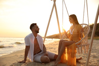 Photo of Happy young couple on beach at sunset