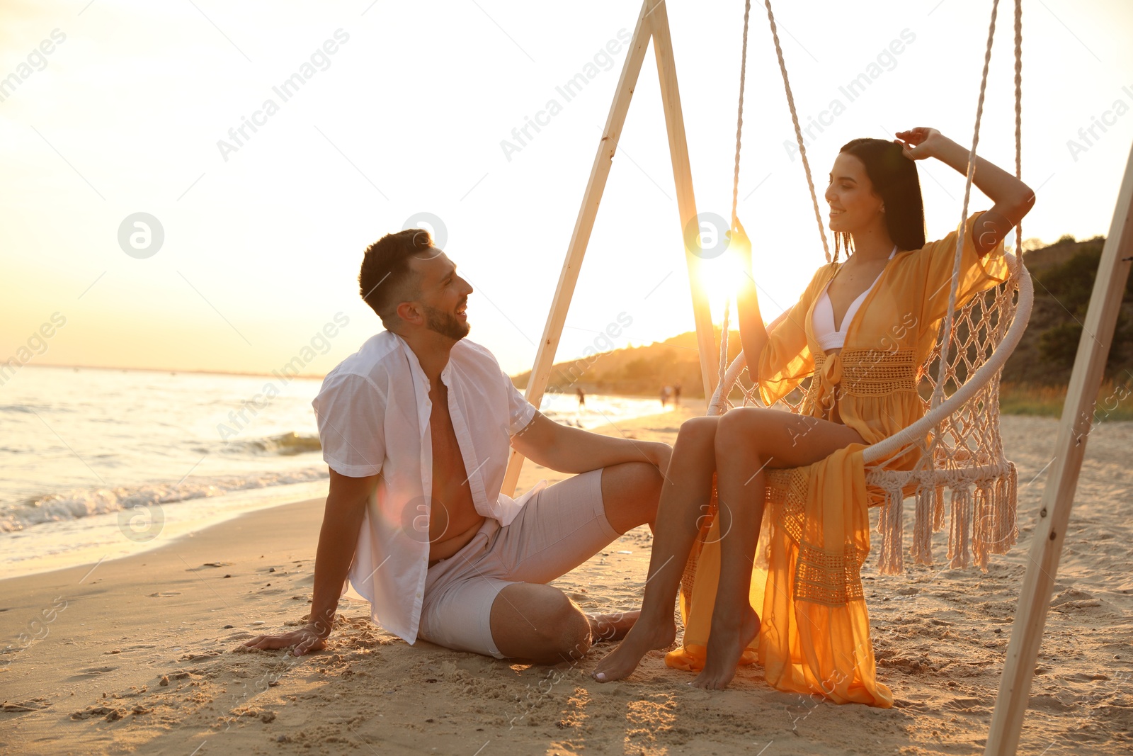 Photo of Happy young couple on beach at sunset