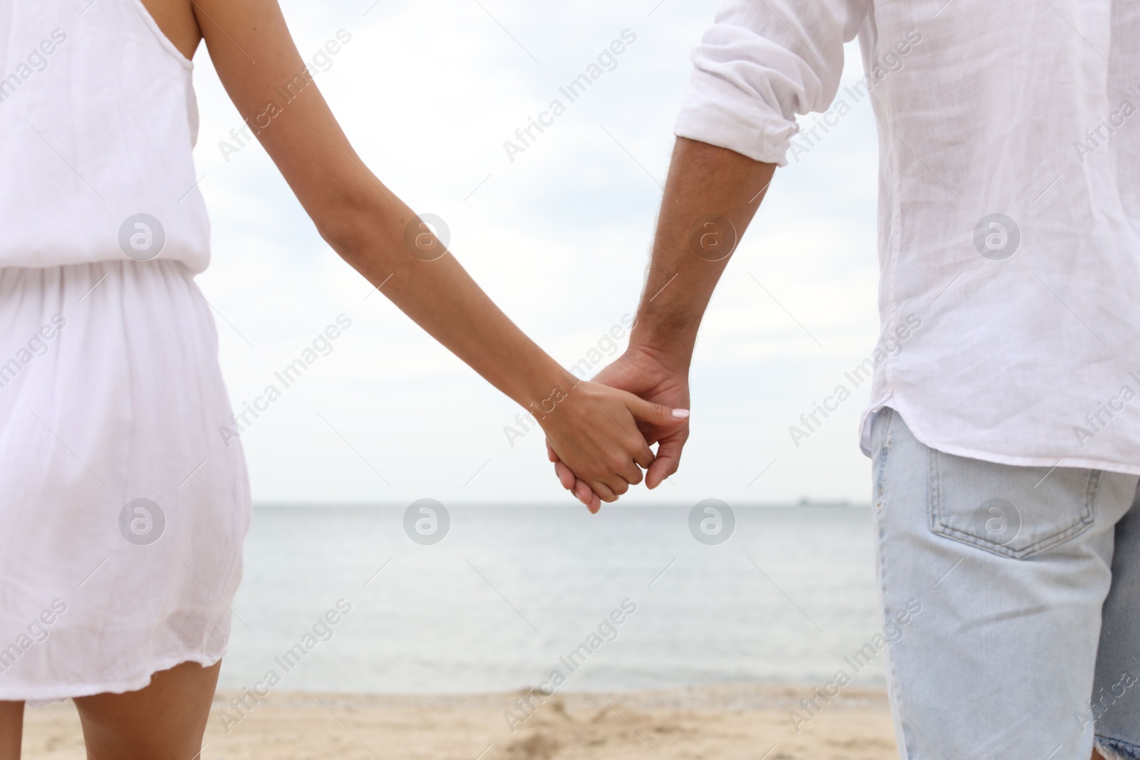 Photo of Lovely couple spending time together on beach, closeup