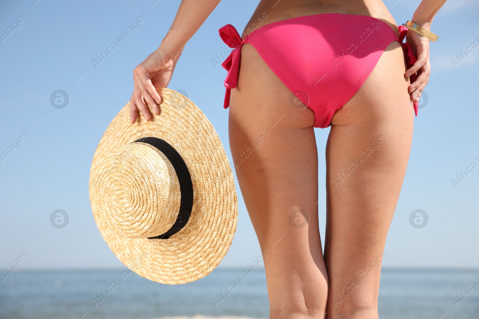 Photo of Young woman with beautiful body on beach, closeup