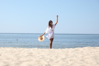 Photo of Young woman with beautiful body on sandy beach. Space for text