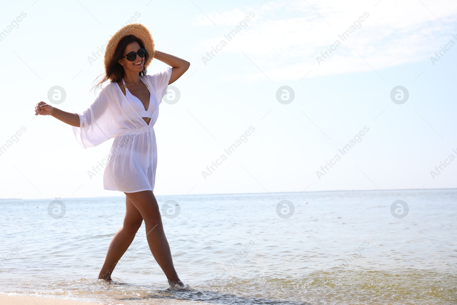 Photo of Young woman with beautiful body on beach. Space for text