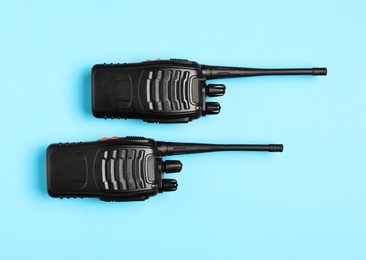 Photo of Walkie talkies on light blue background, top view