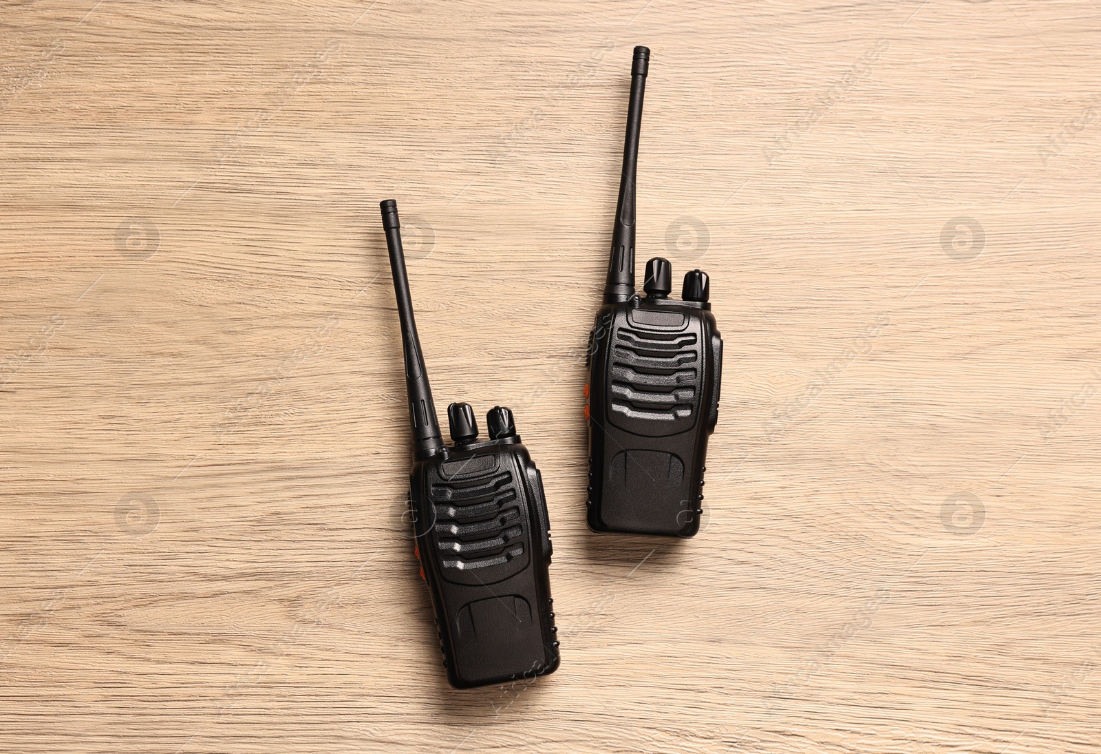 Photo of Walkie talkies on wooden table, top view