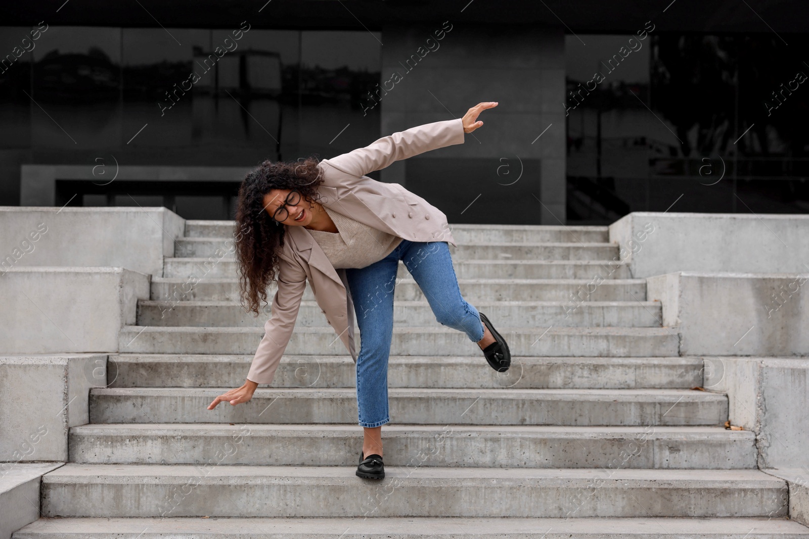 Photo of Woman falling on stairs outdoors. Dangerous accident