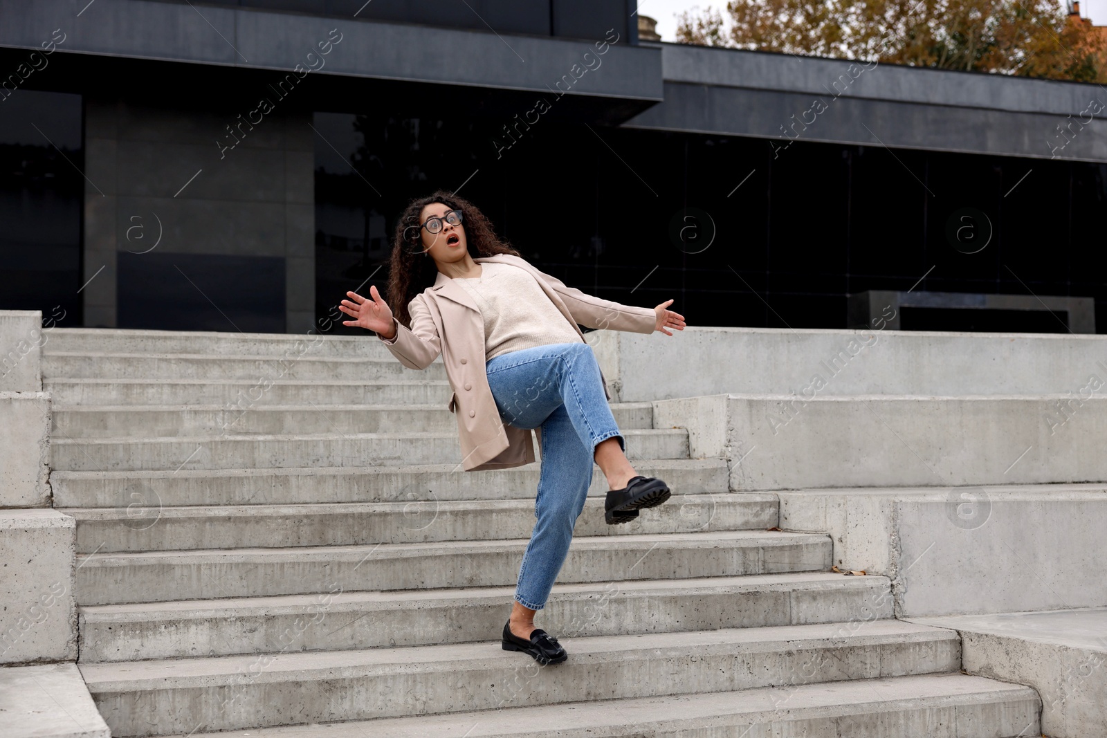 Photo of Woman falling on stairs outdoors. Dangerous accident