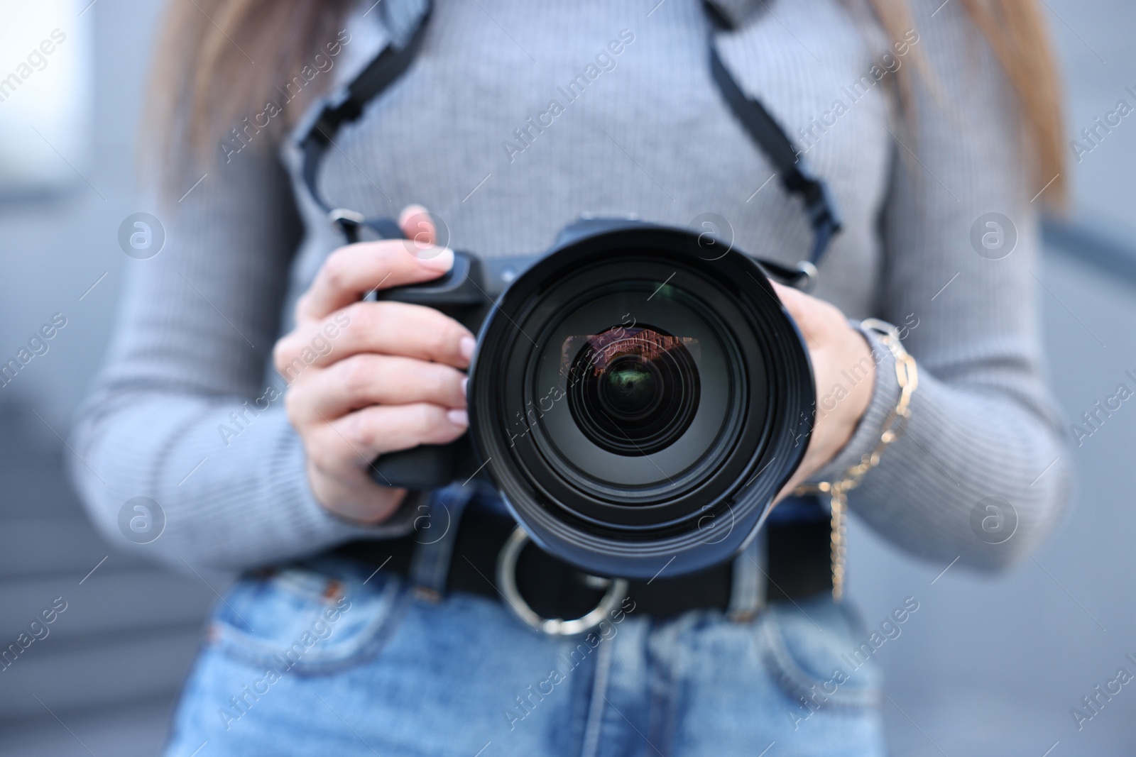 Photo of Professional photographer with digital camera outdoors, closeup