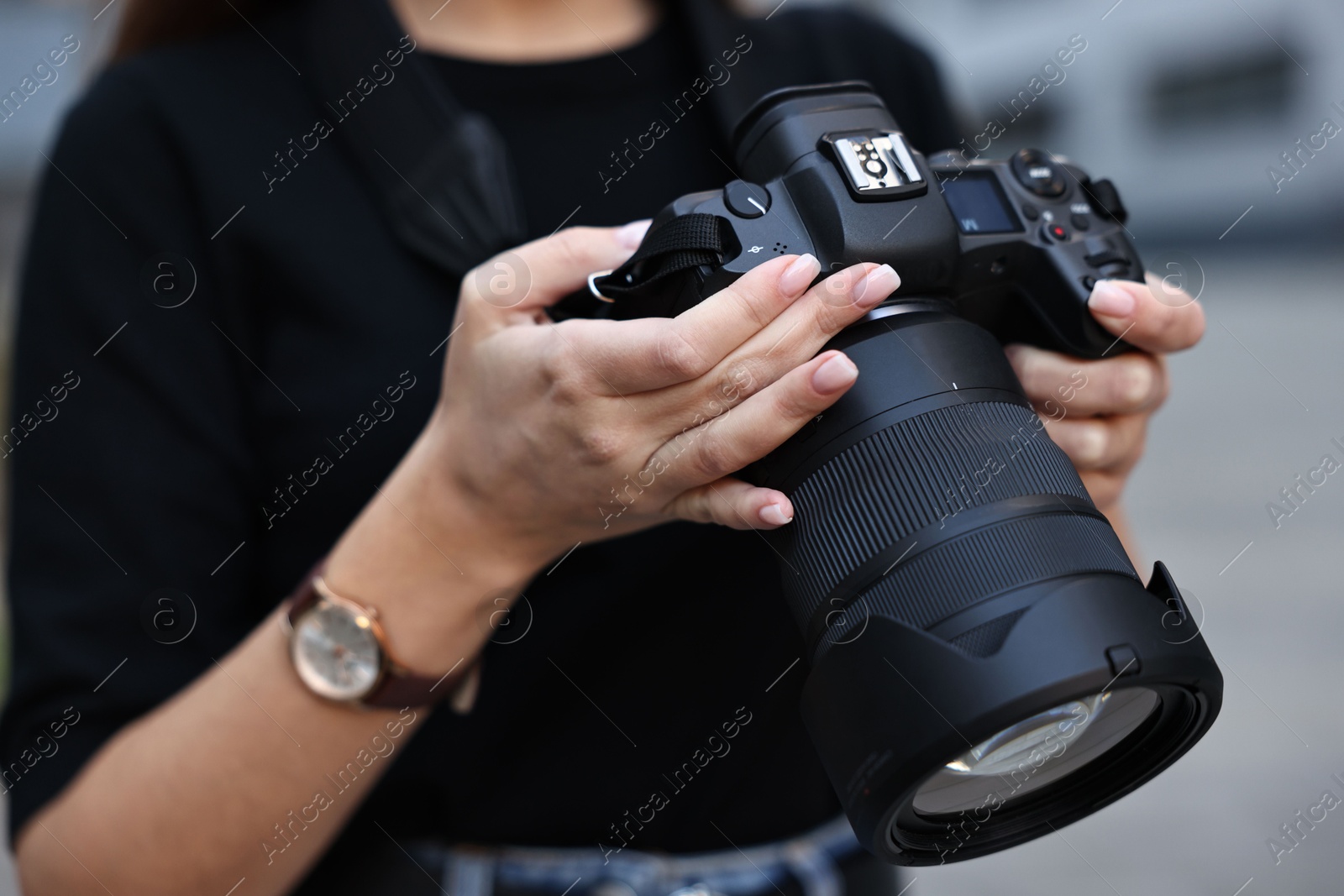 Photo of Professional photographer with digital camera outdoors, closeup