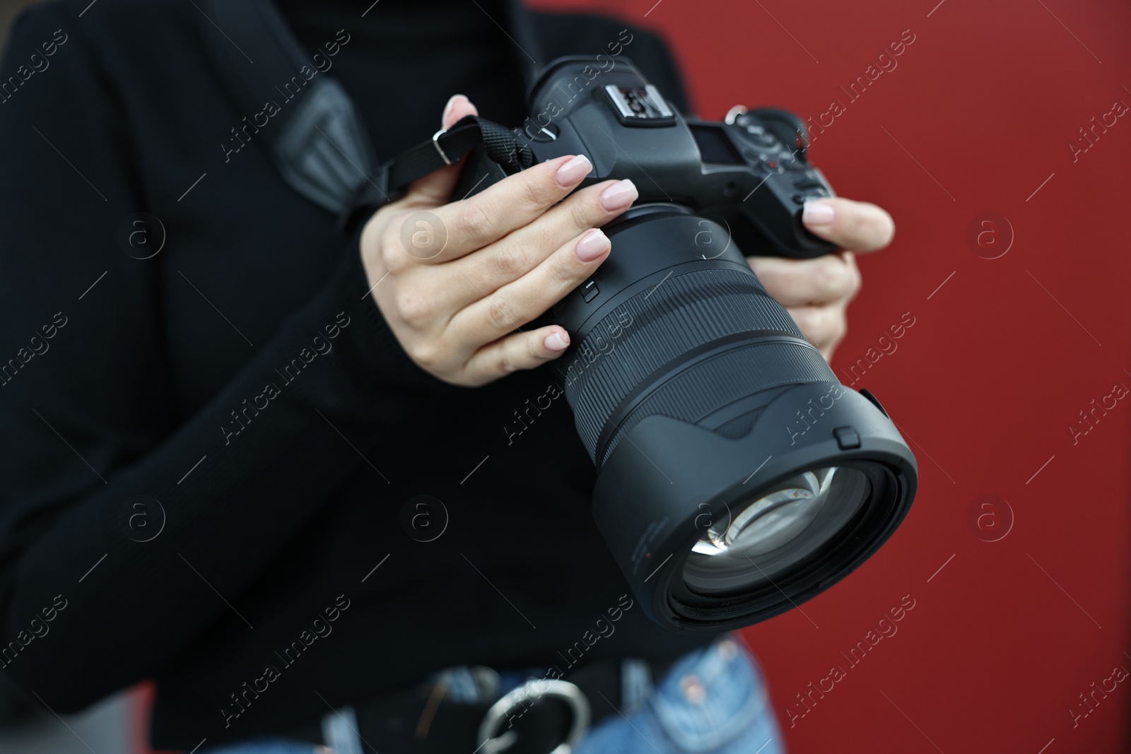 Photo of Professional photographer with digital camera outdoors, closeup