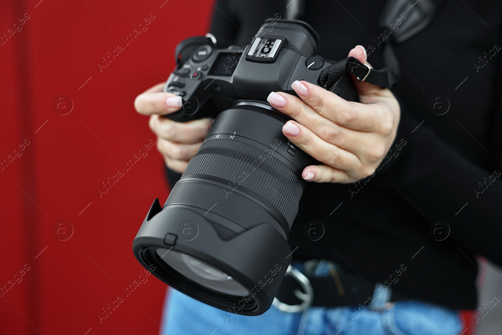 Photo of Professional photographer with digital camera outdoors, closeup