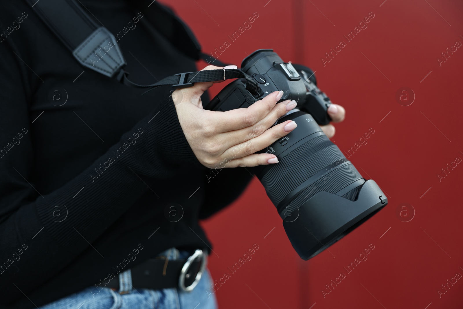 Photo of Professional photographer with digital camera outdoors, closeup