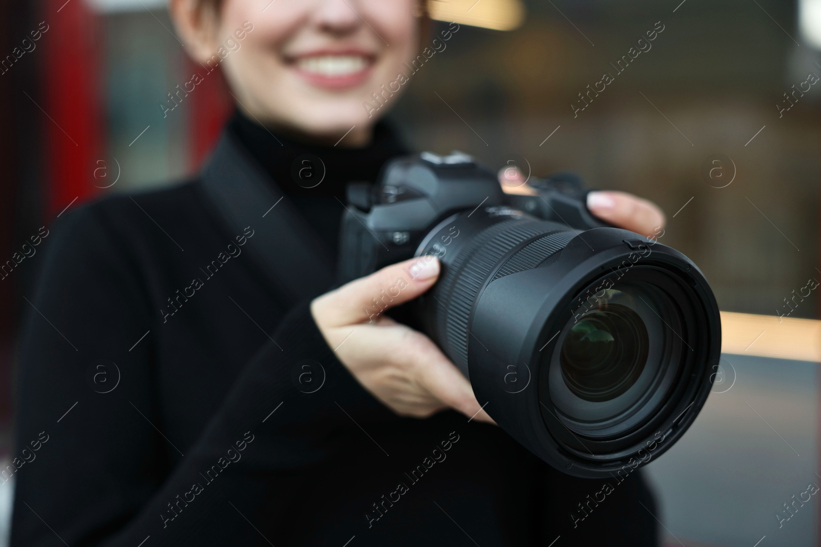 Photo of Professional photographer with digital camera outdoors, closeup