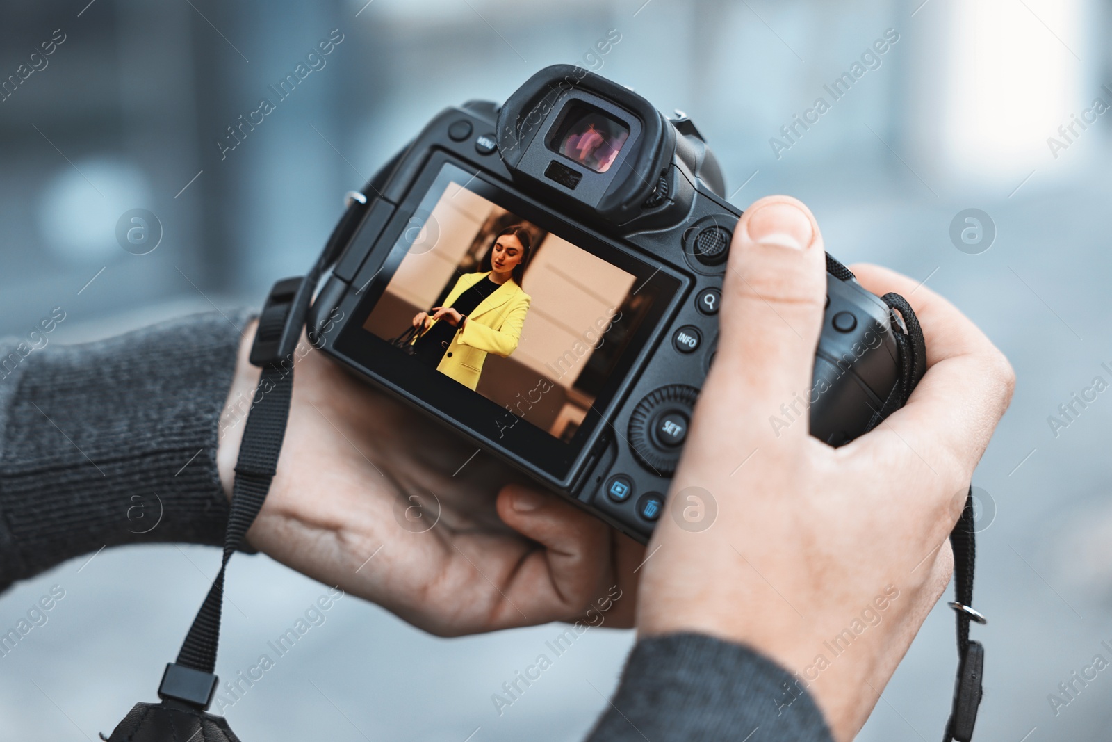 Photo of Professional photographer with modern camera outdoors, closeup