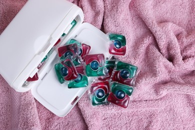 Photo of Laundry detergent capsules on terry towel, top view