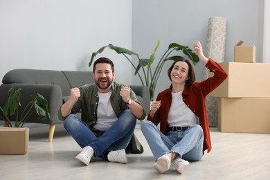 Photo of Moving day. Happy couple having fun in their new home