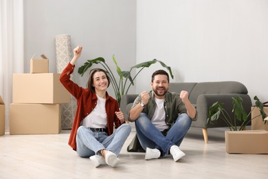 Photo of Moving day. Happy couple having fun in their new home