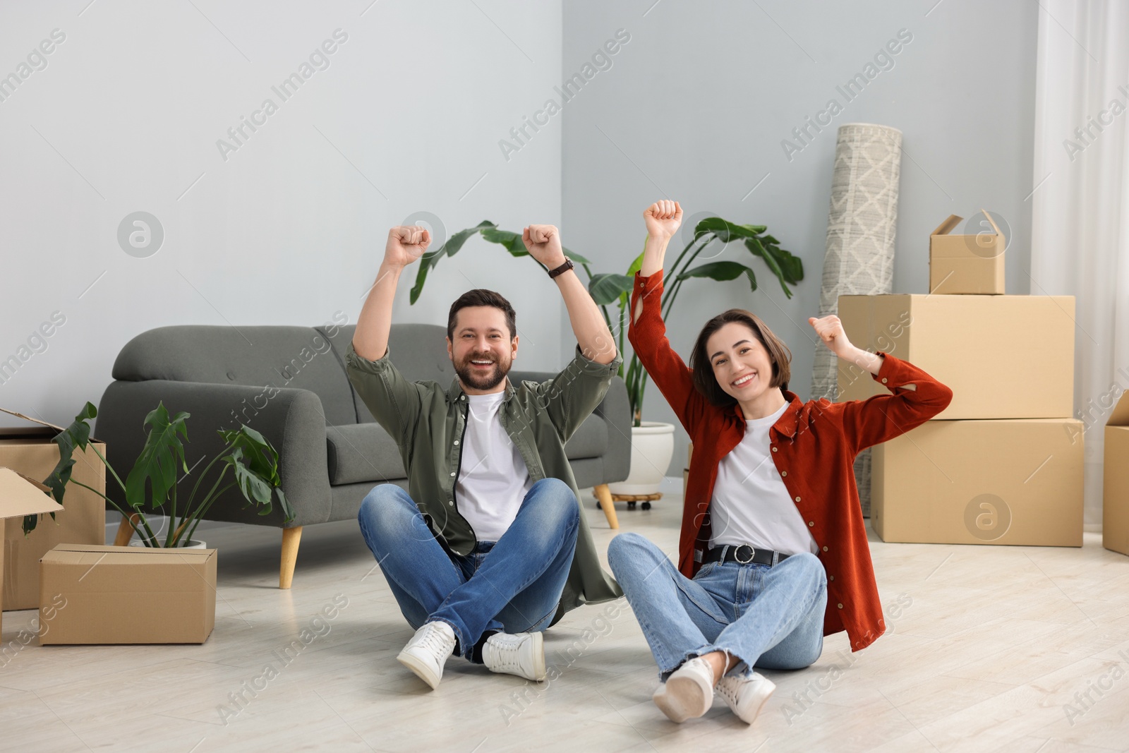 Photo of Moving day. Happy couple having fun in their new home