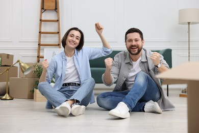 Photo of Moving day. Happy couple having fun in their new home