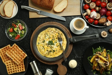 Photo of Tasty food served for brunch on black table, flat lay