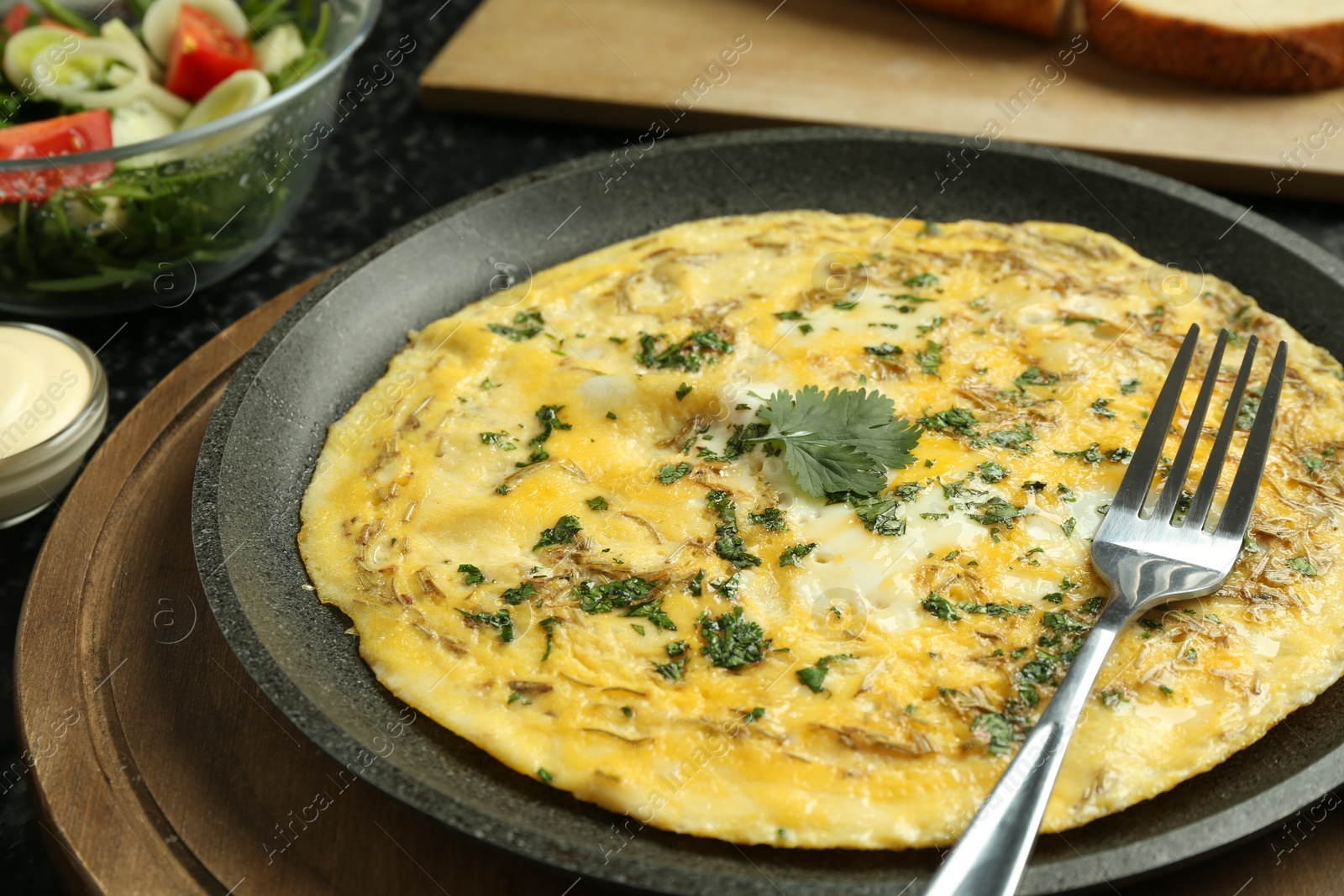 Photo of Tasty brunch. Delicious omelette and salad served on table, closeup