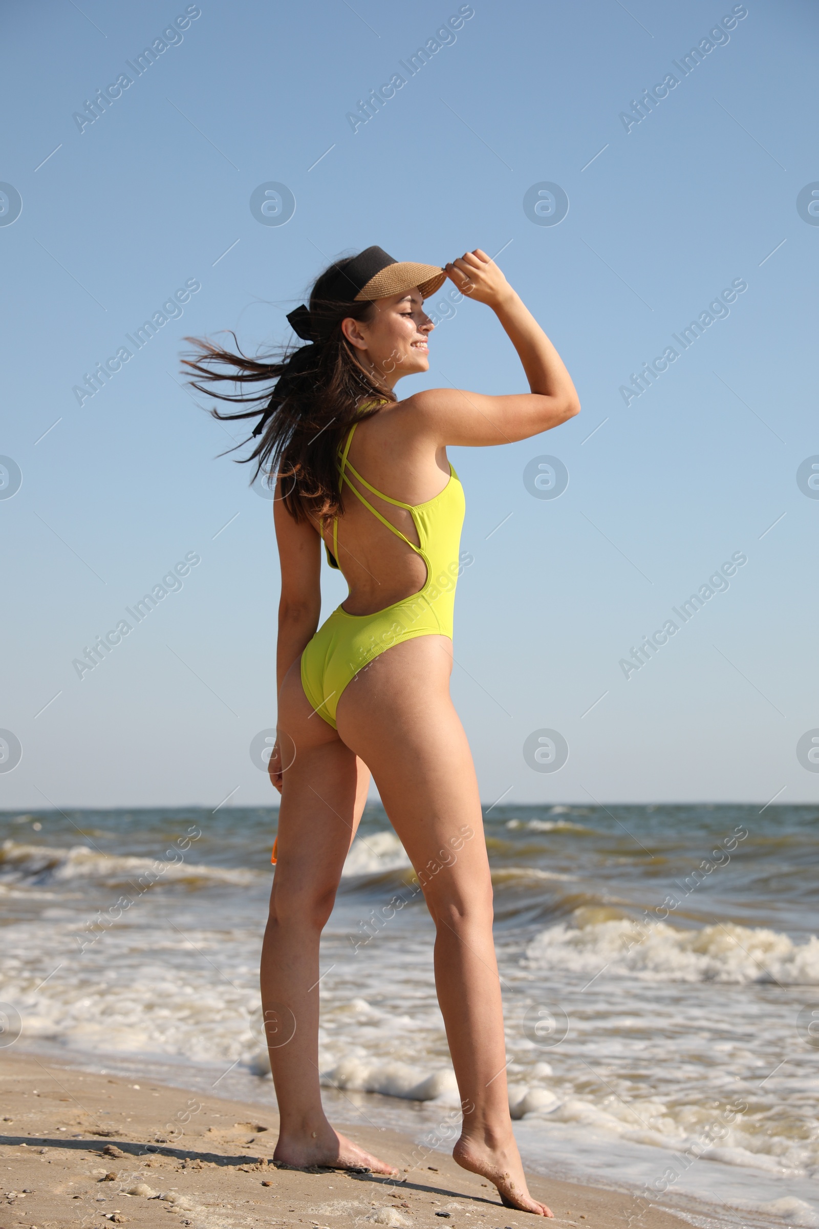 Photo of Beautiful young woman with attractive body on beach