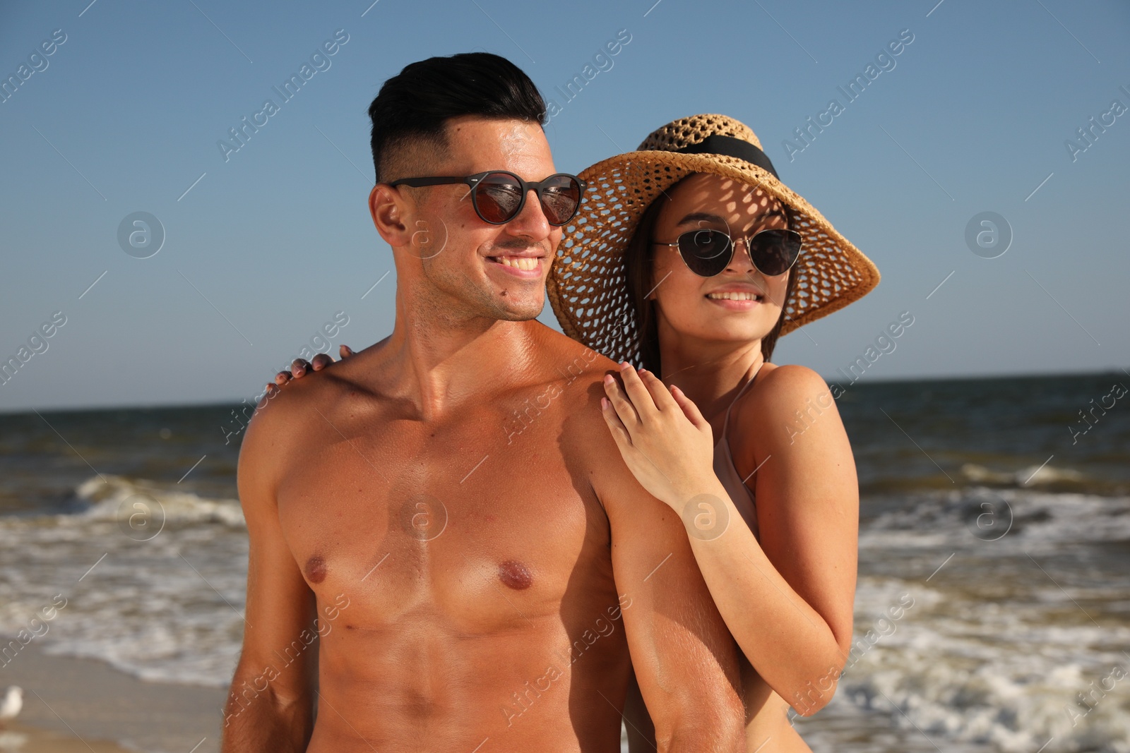 Photo of Lovely couple spending time together on beach