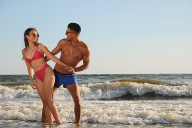 Photo of Lovely couple spending time together on beach