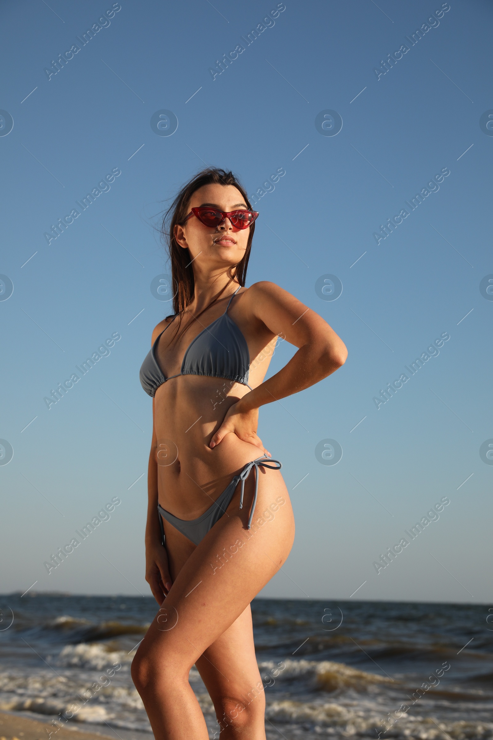 Photo of Beautiful young woman with attractive body on beach