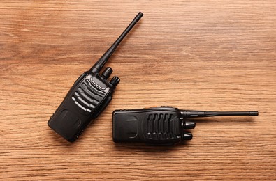 Photo of Walkie talkies on wooden table, top view