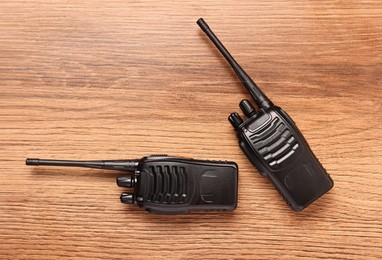 Photo of Walkie talkies on wooden table, top view