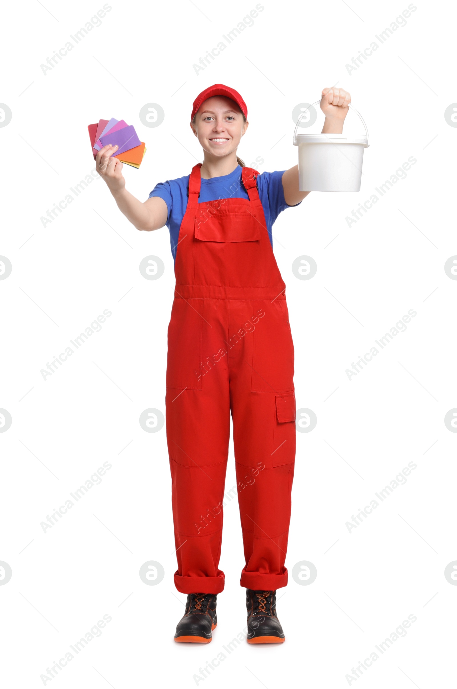 Photo of Professional painter with color samples and bucket of paint on white background