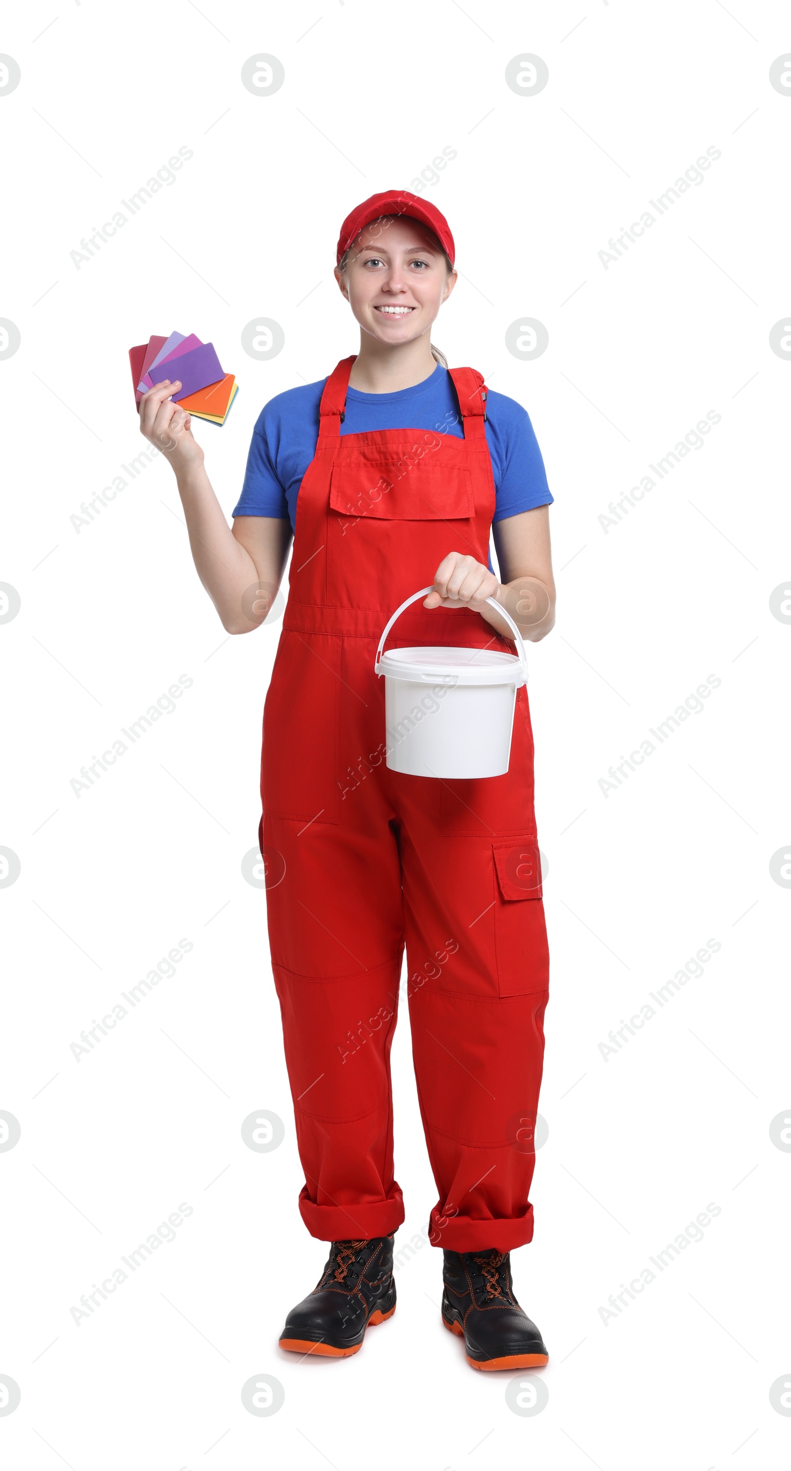 Photo of Professional painter with color samples and bucket of paint on white background