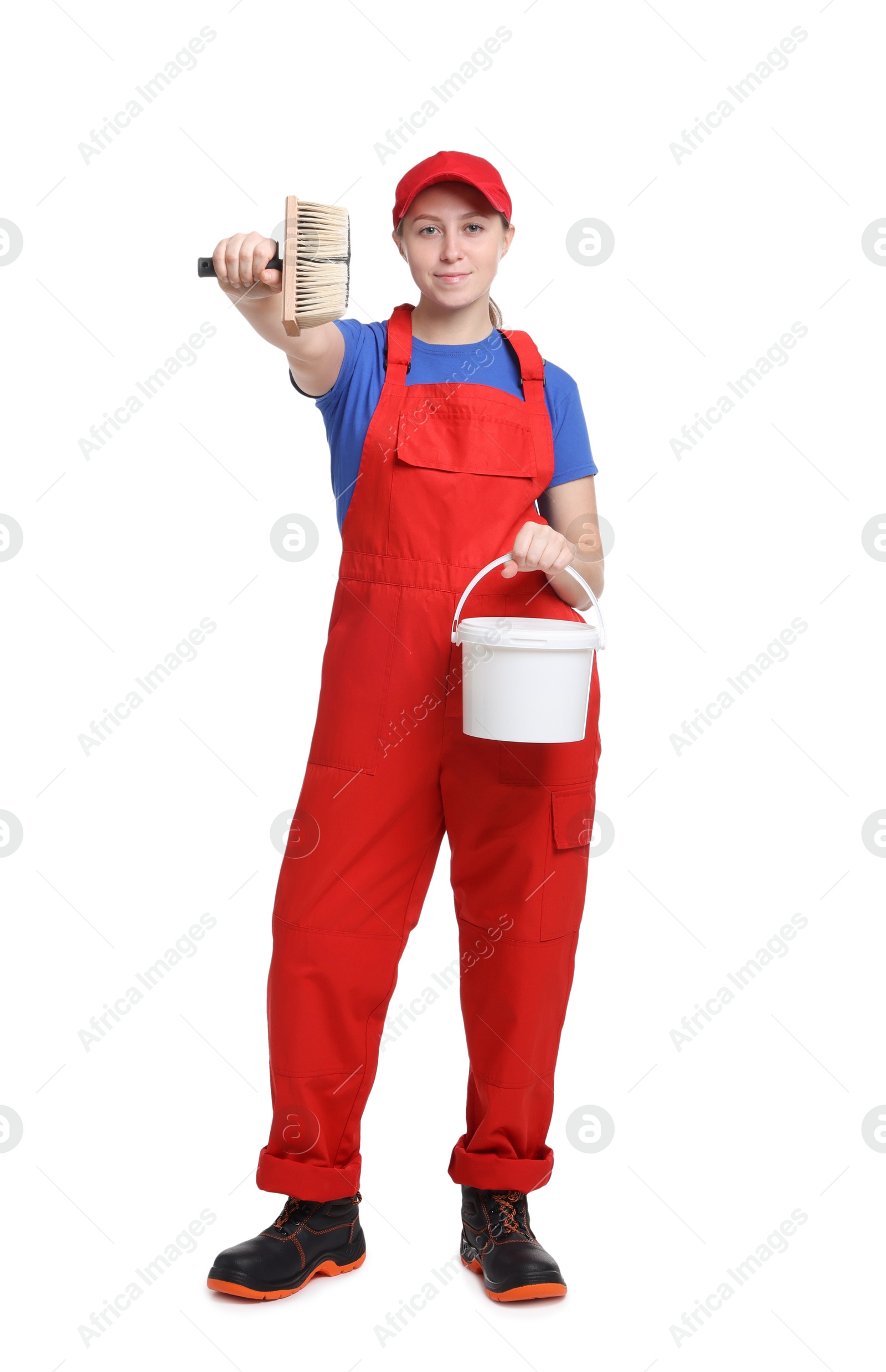 Photo of Professional painter with brush and bucket of paint on white background